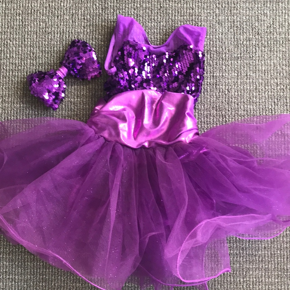 Purple sequined costume and bow.